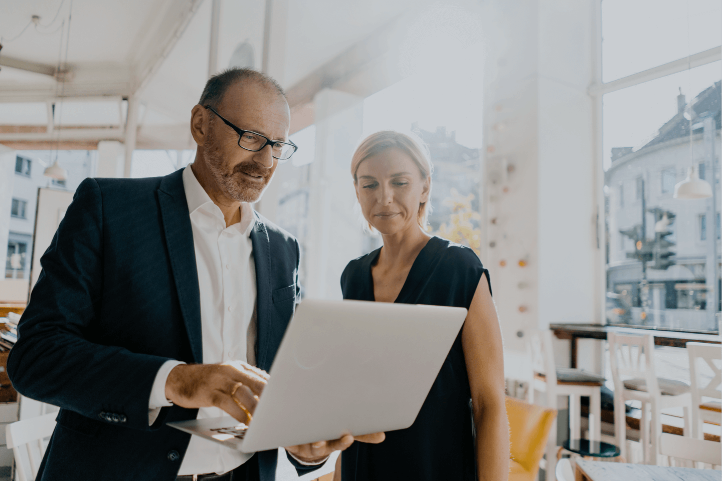 Executives looking at a denials report on a laptop