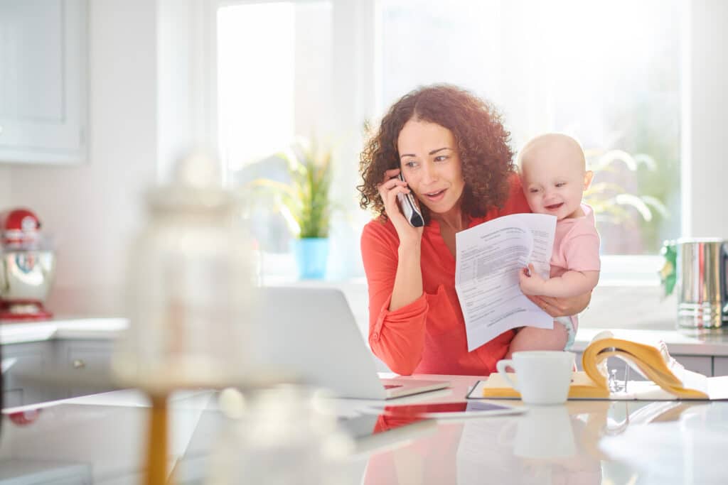 mother holding baby on the phone with medical billing office