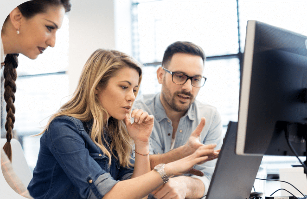 A picture of a group looking at a denial prevention dashboard on a computer