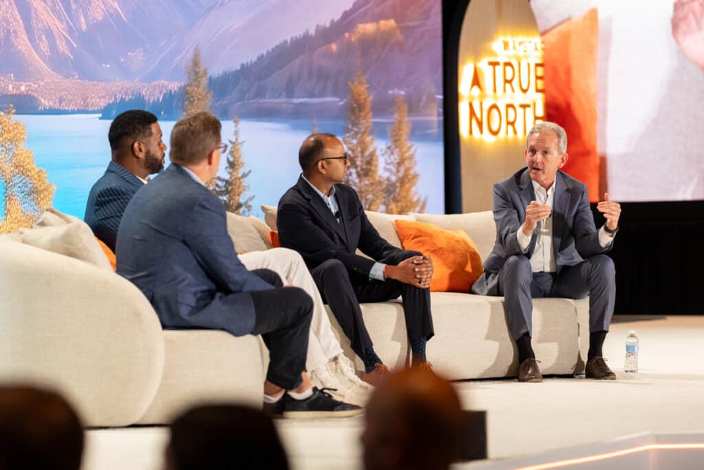 Four panelists sit on a couch on stage to discuss the latest RCM innovations at Waystar True North 2026.